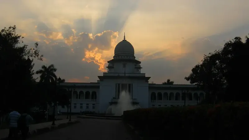 সন্ধ্যার আকাশের নিচে গম্বুজওয়ালা সাদা সুপ্রিম কোর্ট ভবন, সামনে ফোয়ারা ও গাছের সারি